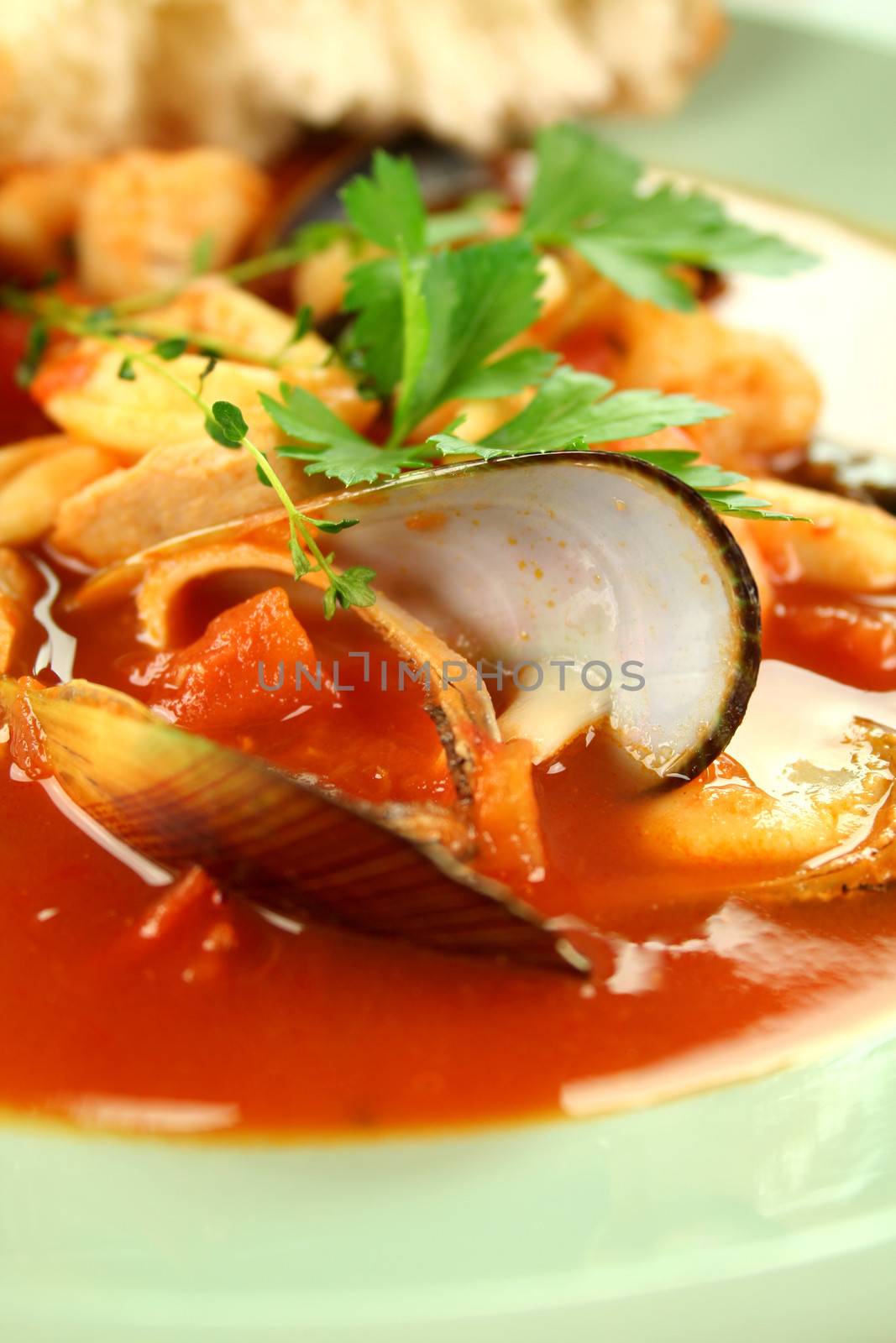 Delicious Mediterranean style tomato seafood soup with mussels and mixed seafood.