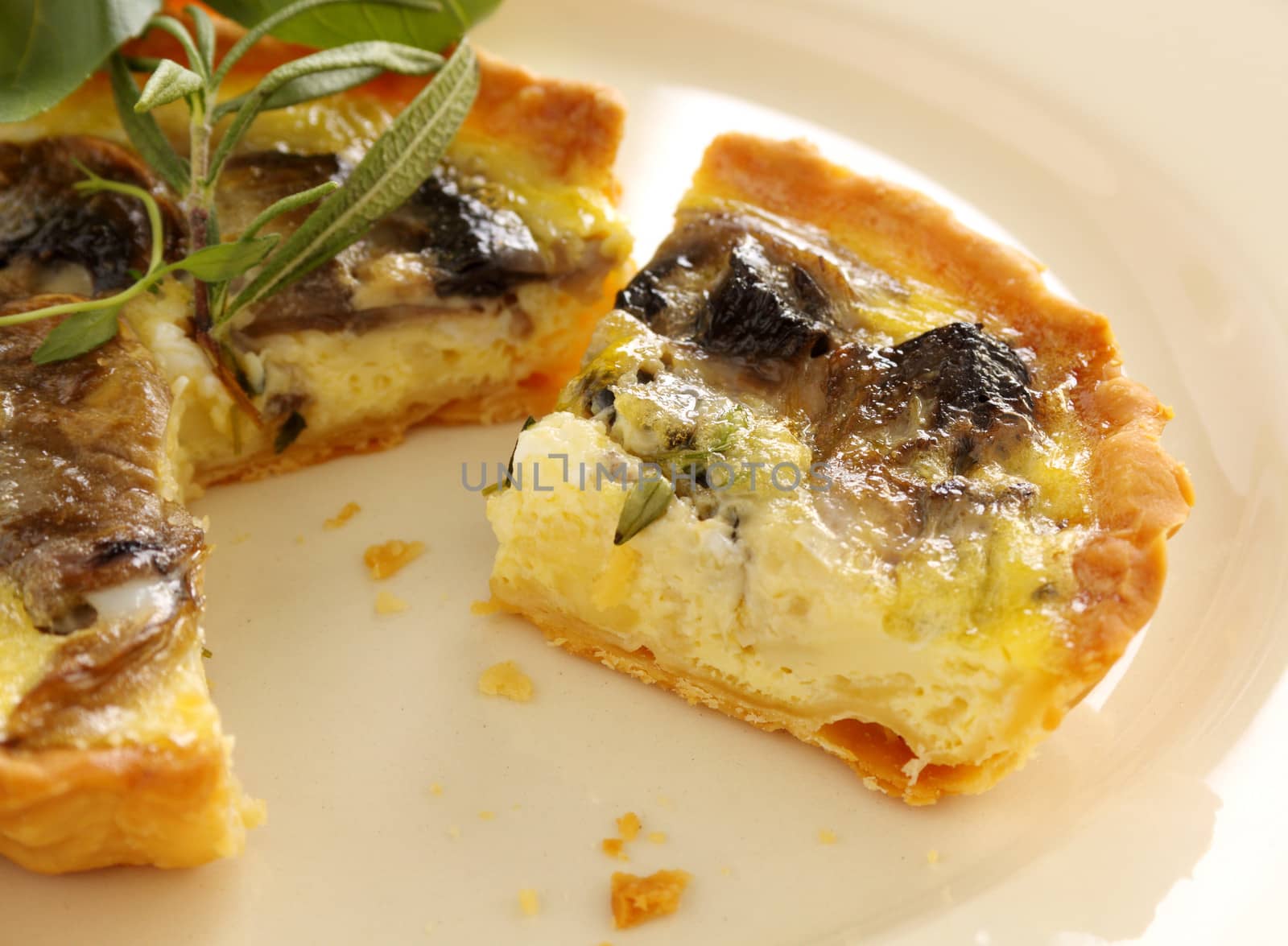 Fresh baked mushroom quiche sliced and ready to serve.