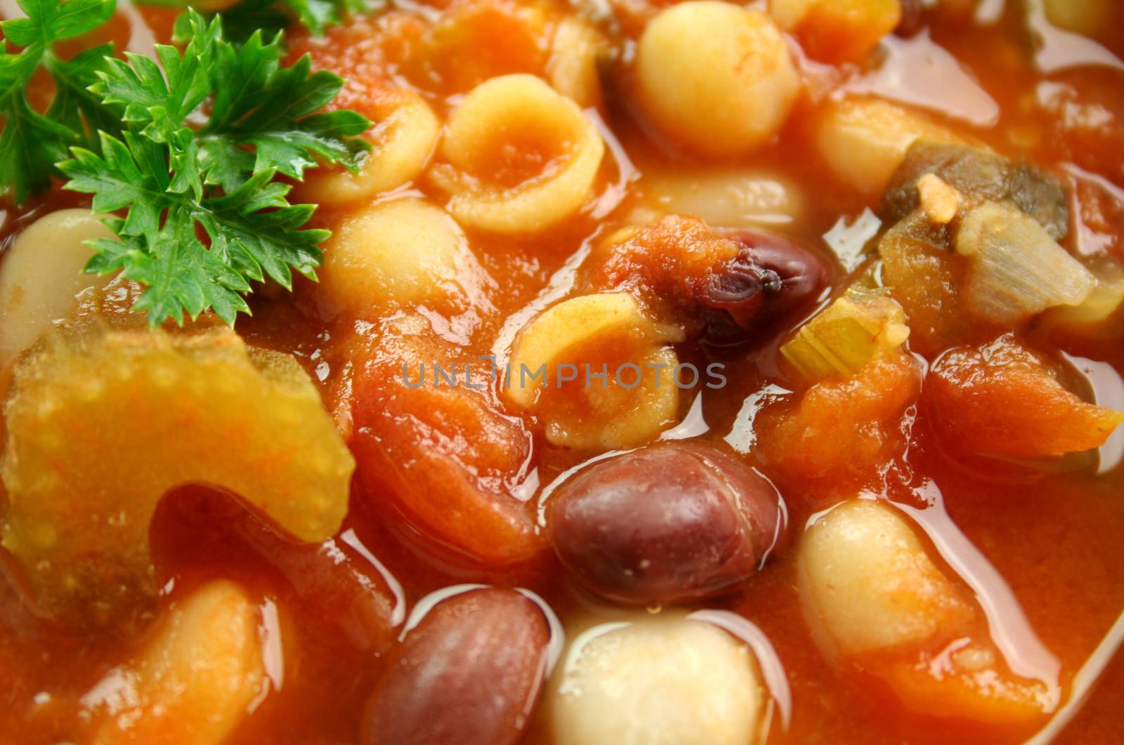 Close up of delicious freshly made Italian minestrone soup with parsley.