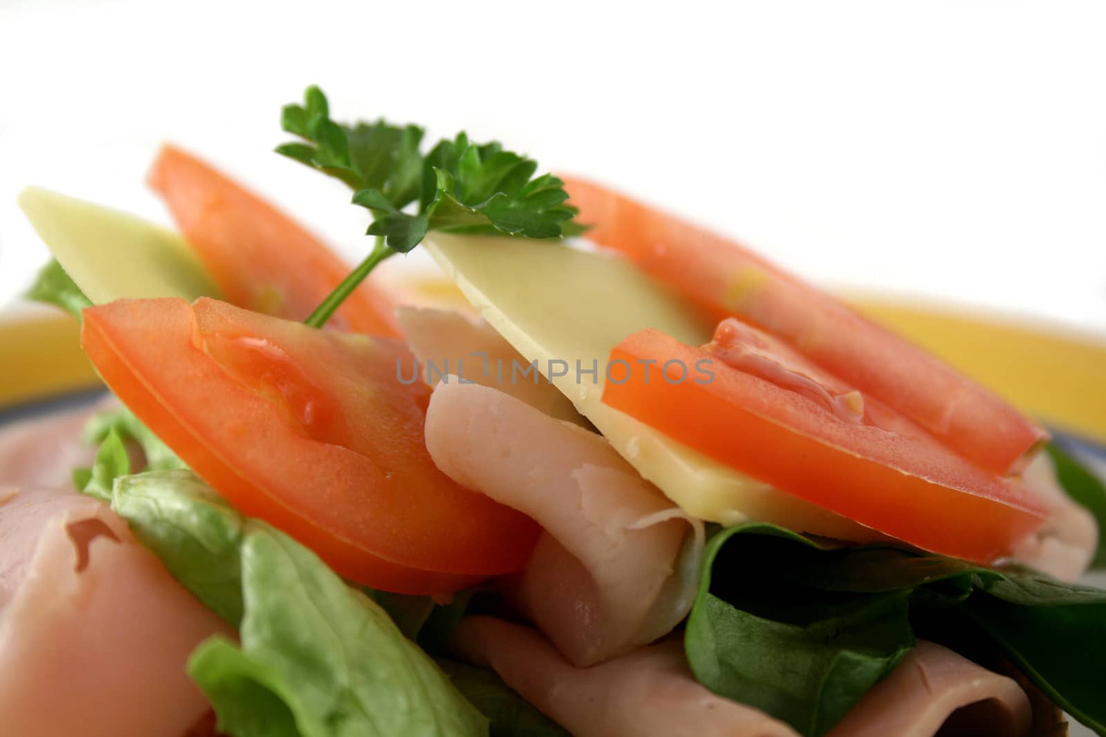 Ham, lettuce, tomato and cheese open sandwich on wholemeal bread.