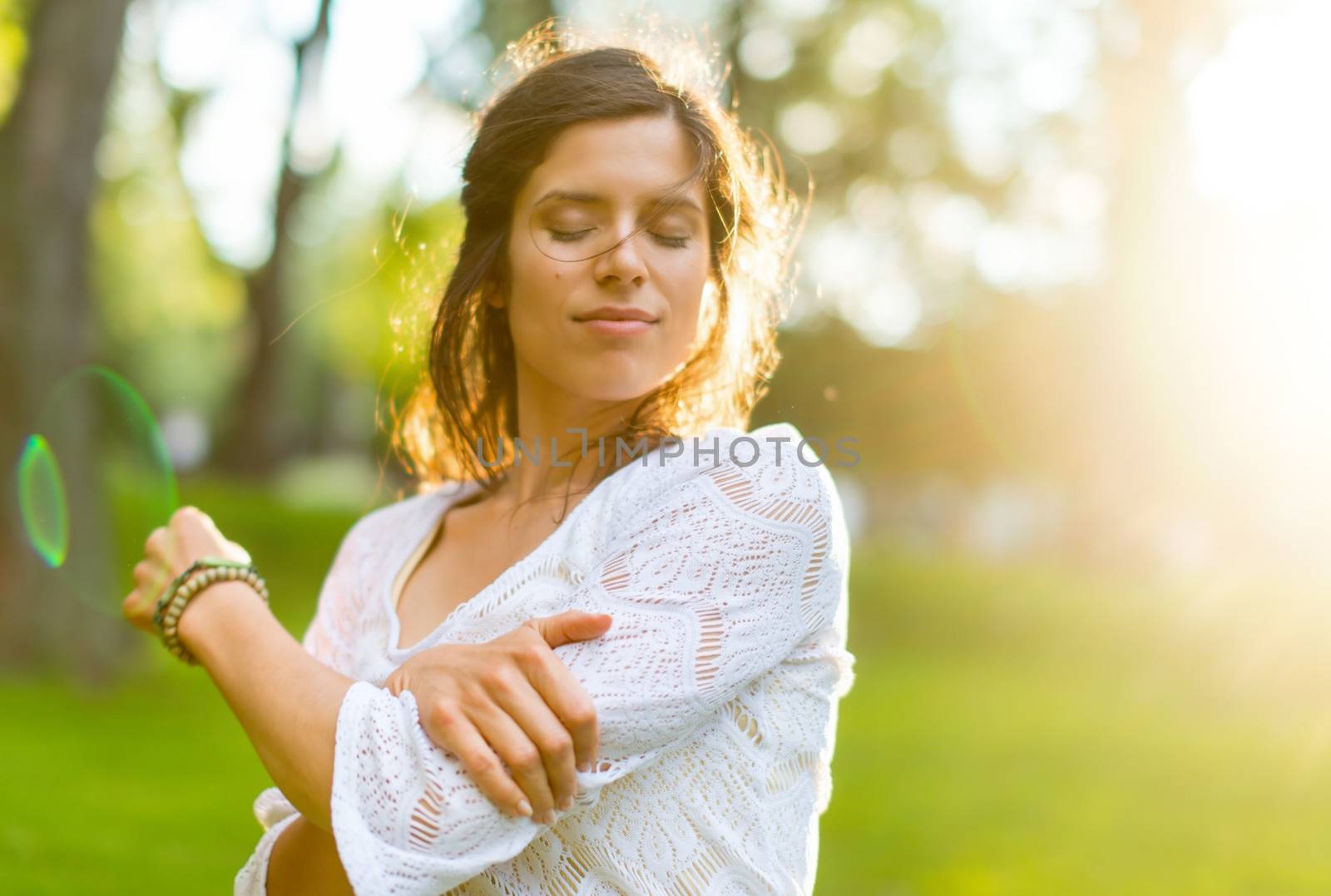 Beauty portrait of an attractive multi-ethnic girl enjoying the warmth of a summer sunset. Sun Flare serie
