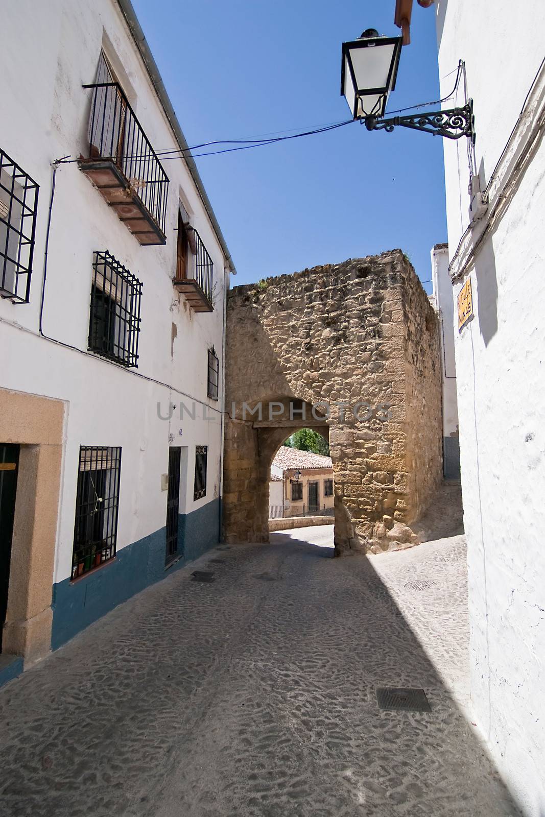 Mudejar door to the village at the end of the street,  Sabiote, Jaen province, Andalusia, Spain