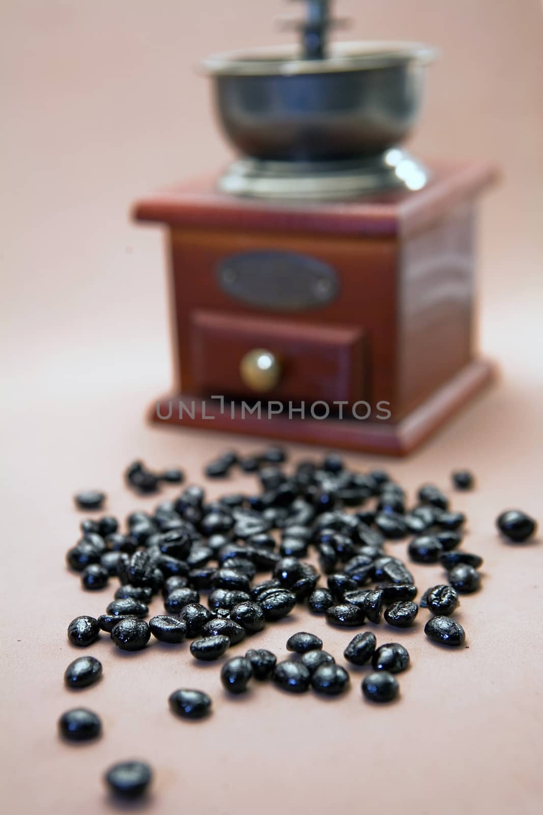 Roasted coffee beans are ground in a coffee grinder