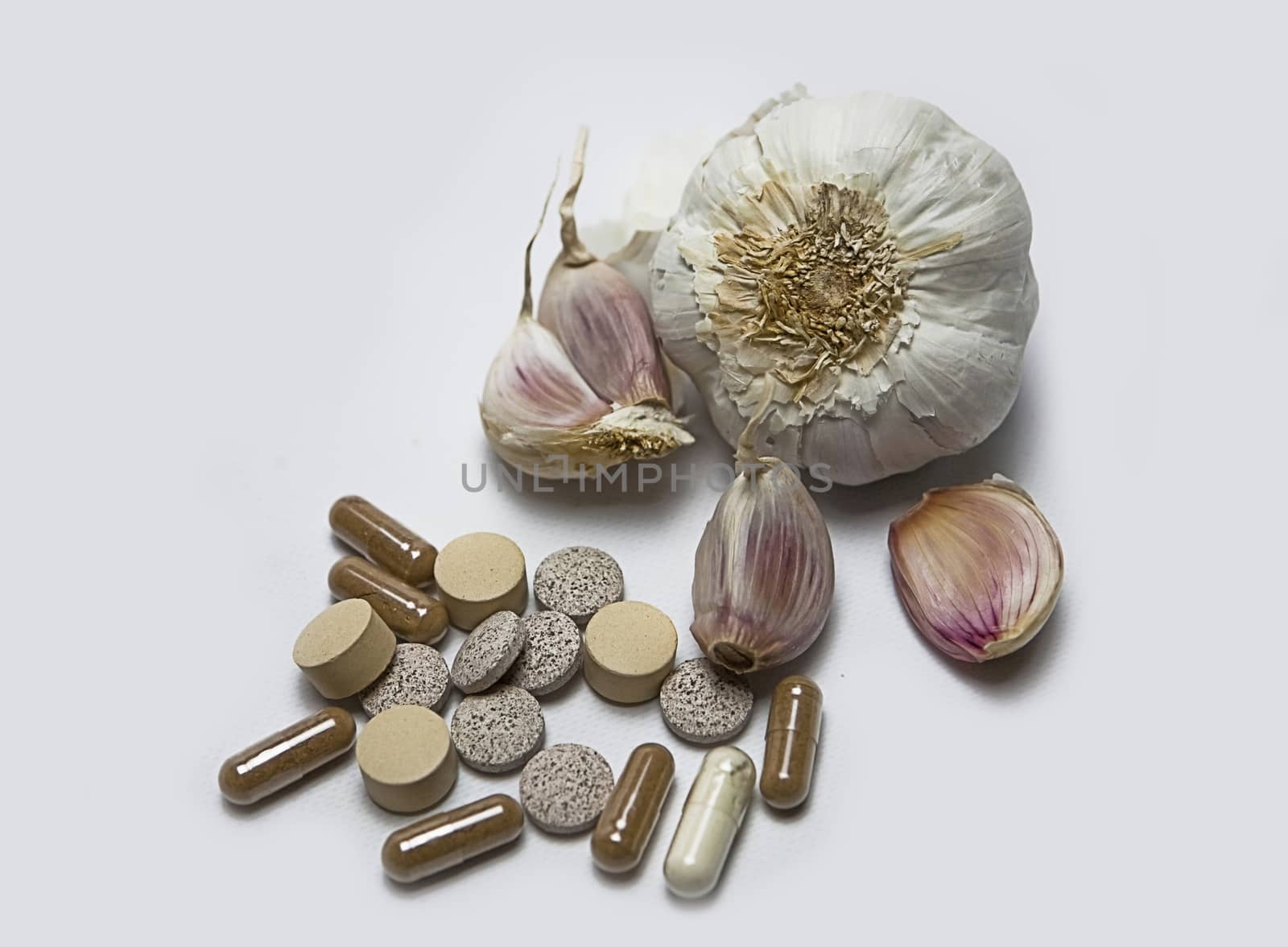 Garlic and herbal supplement pills, alternative medicine concept