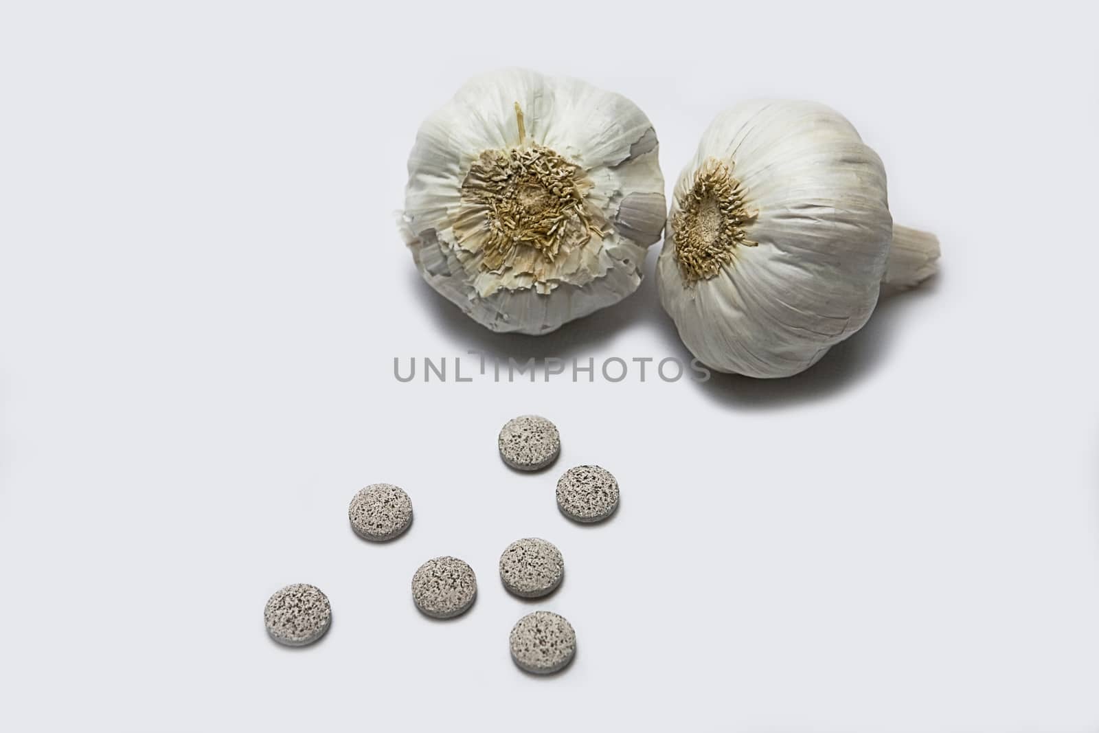 Garlic and herbal supplement pills, alternative medicine concept