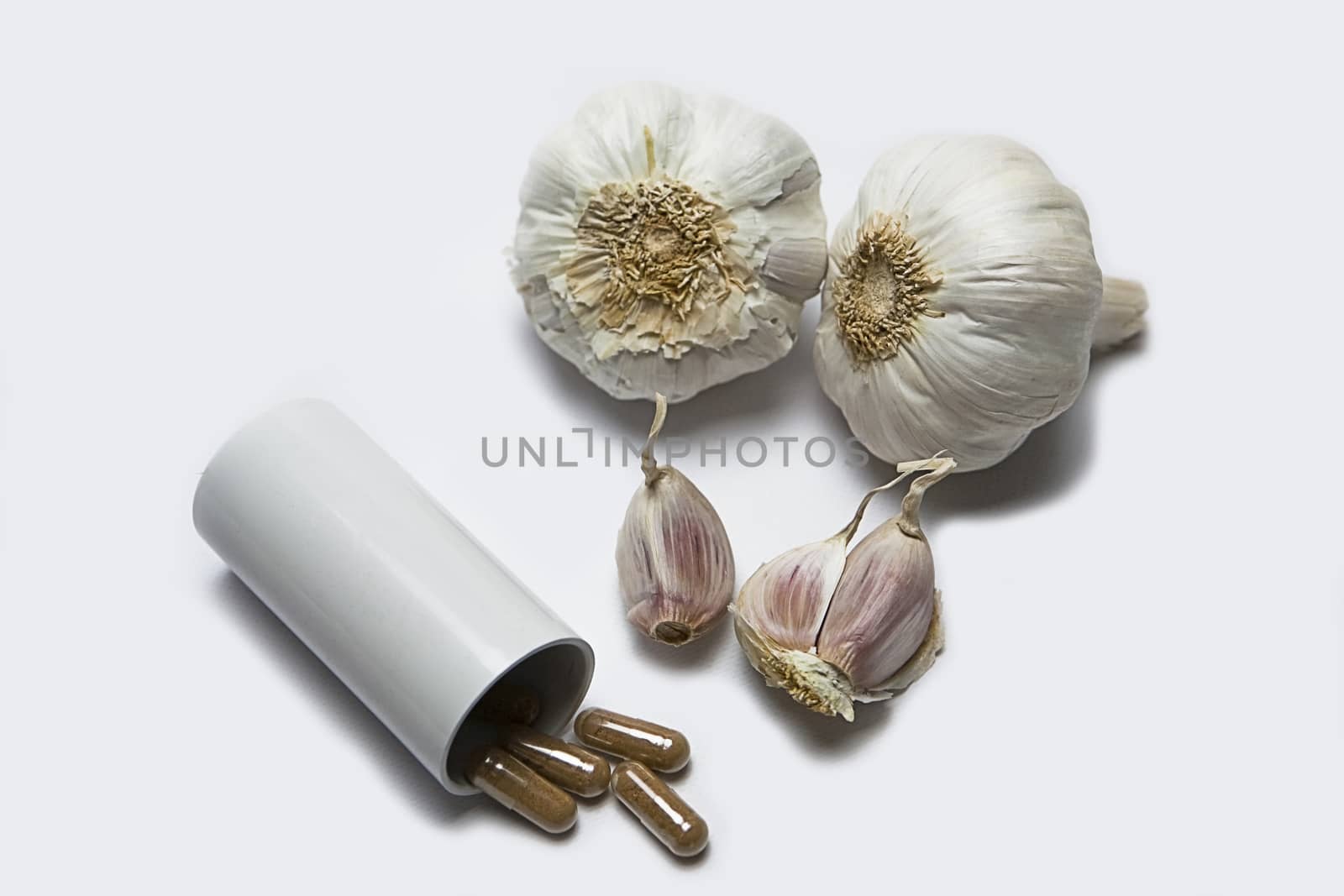 Garlic and herbal supplement pills, alternative medicine concept