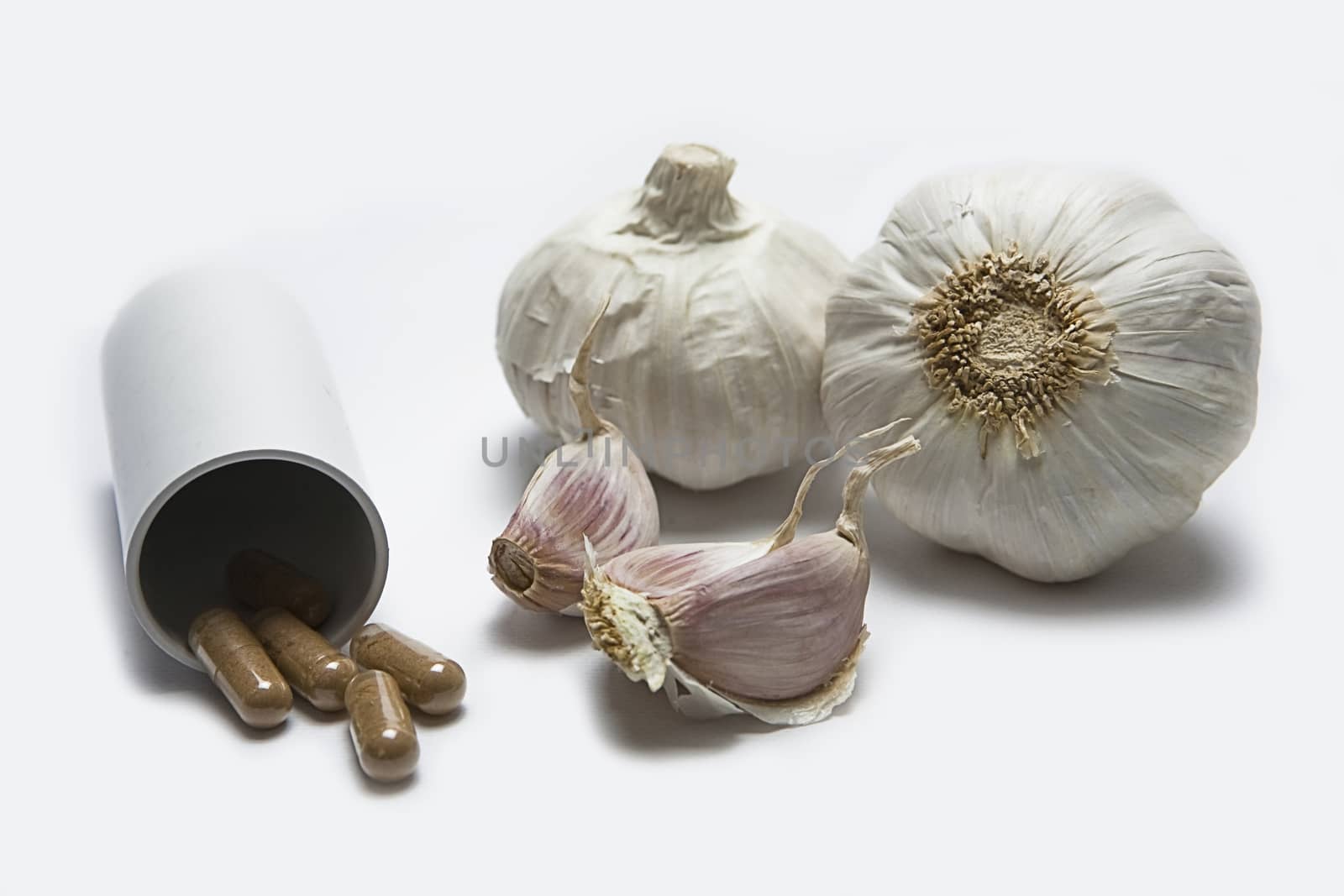 Garlic and herbal supplement pills, alternative medicine concept