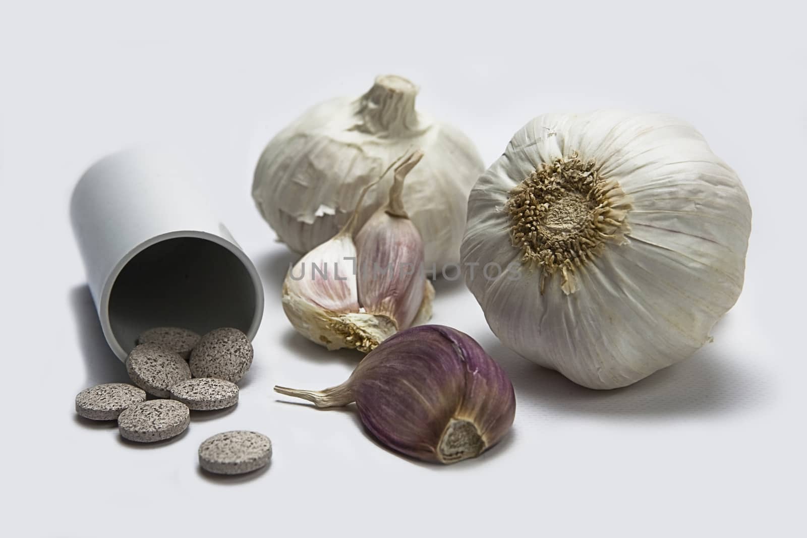 Garlic and herbal supplement pills, alternative medicine concept