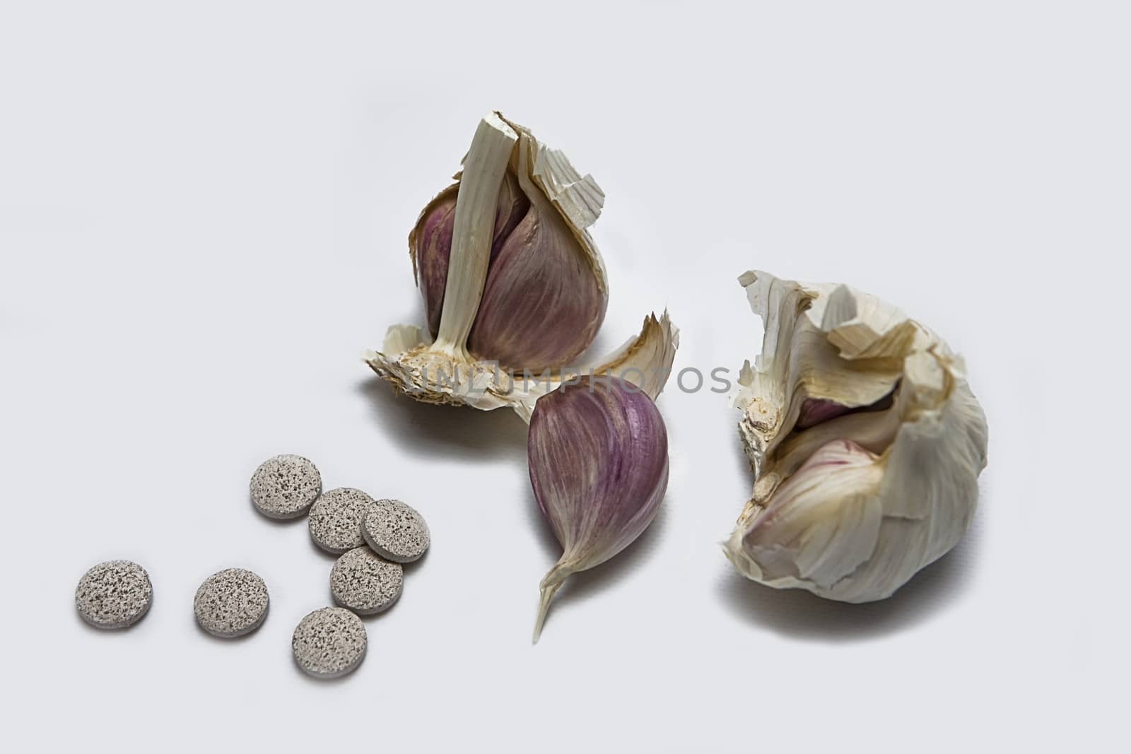 Garlic and herbal supplement pills, alternative medicine concept