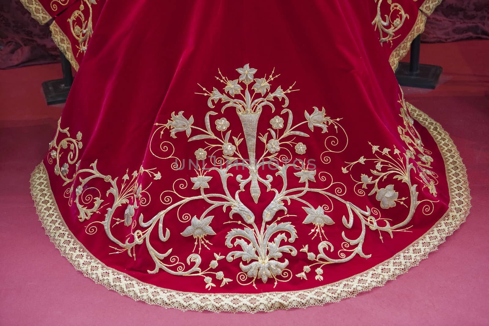 Embroidering with gold thread work on red velvet, Spain