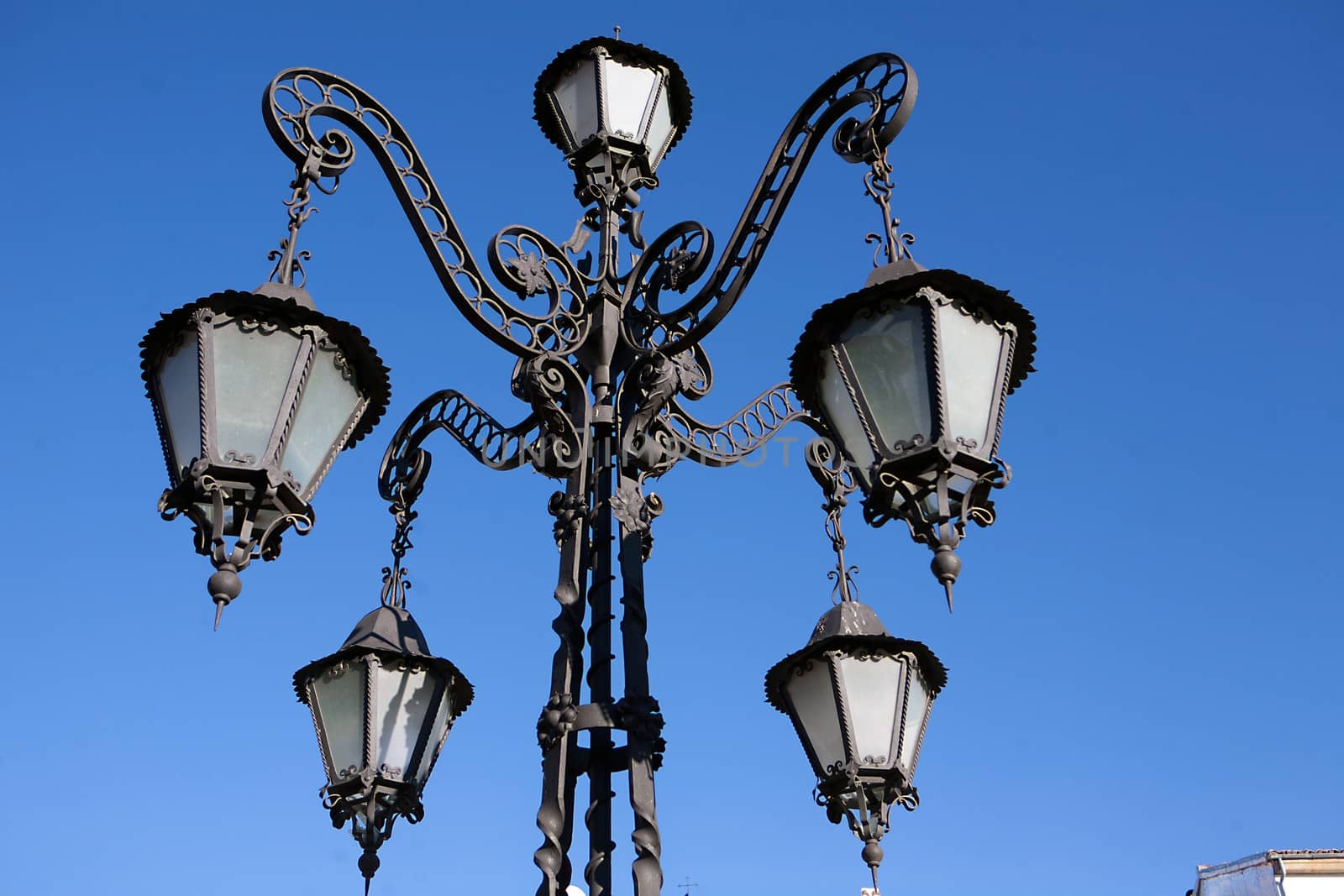 A wrought iron lamp on a weathered wall in First of May Square, Ubeda, province of Jaen, Spain