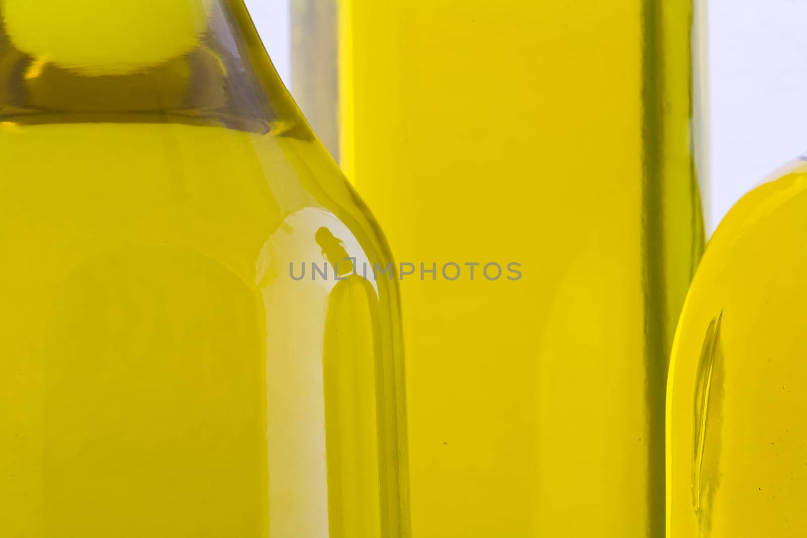Branch with olives and a bottle of olive oil isolated on white