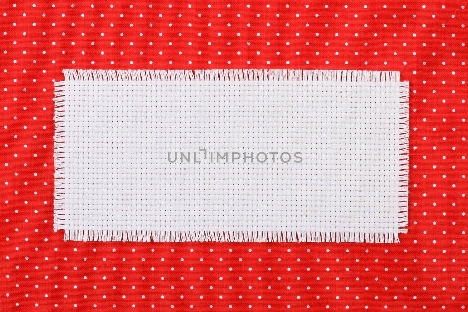 Frame made ������of white canvas on a red fabric