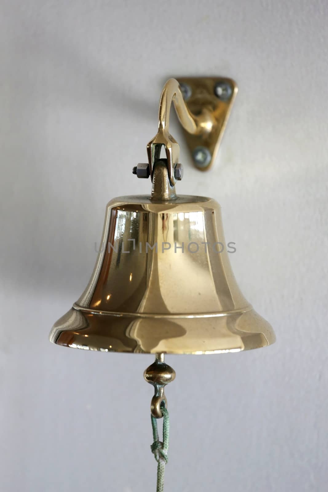 Vintage brass bell mounted on a wall