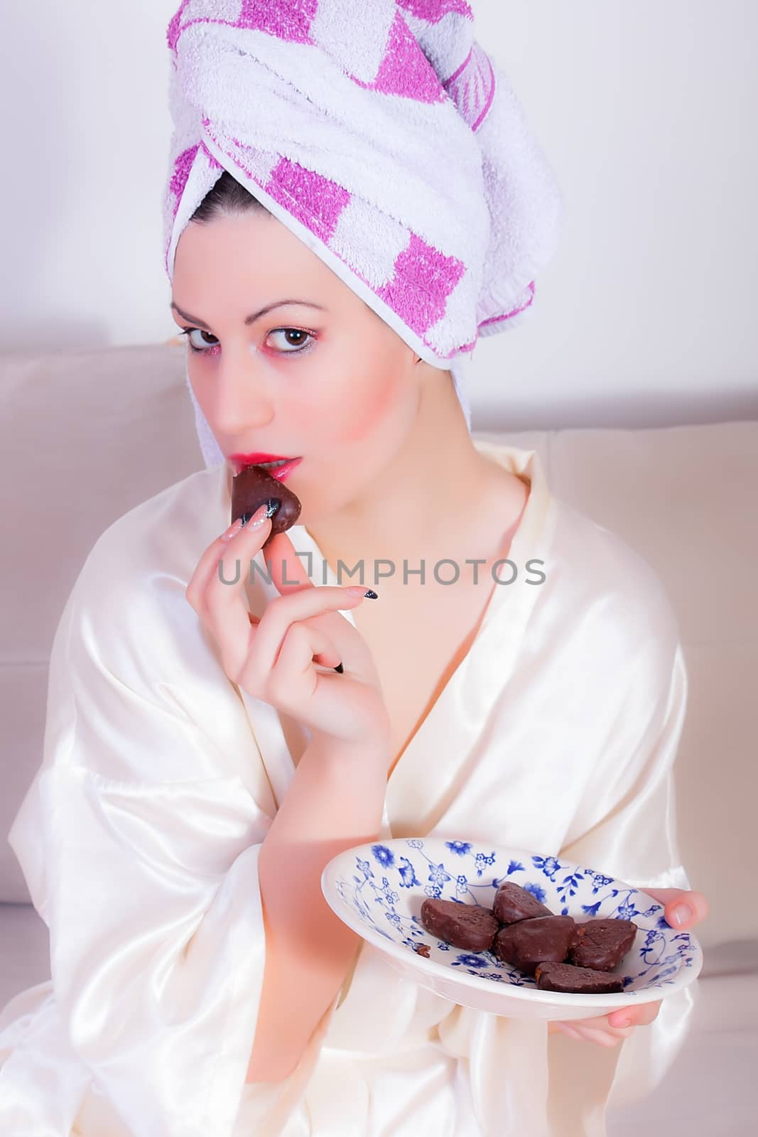 portrait of beautiful girl is eating chocolate cookies