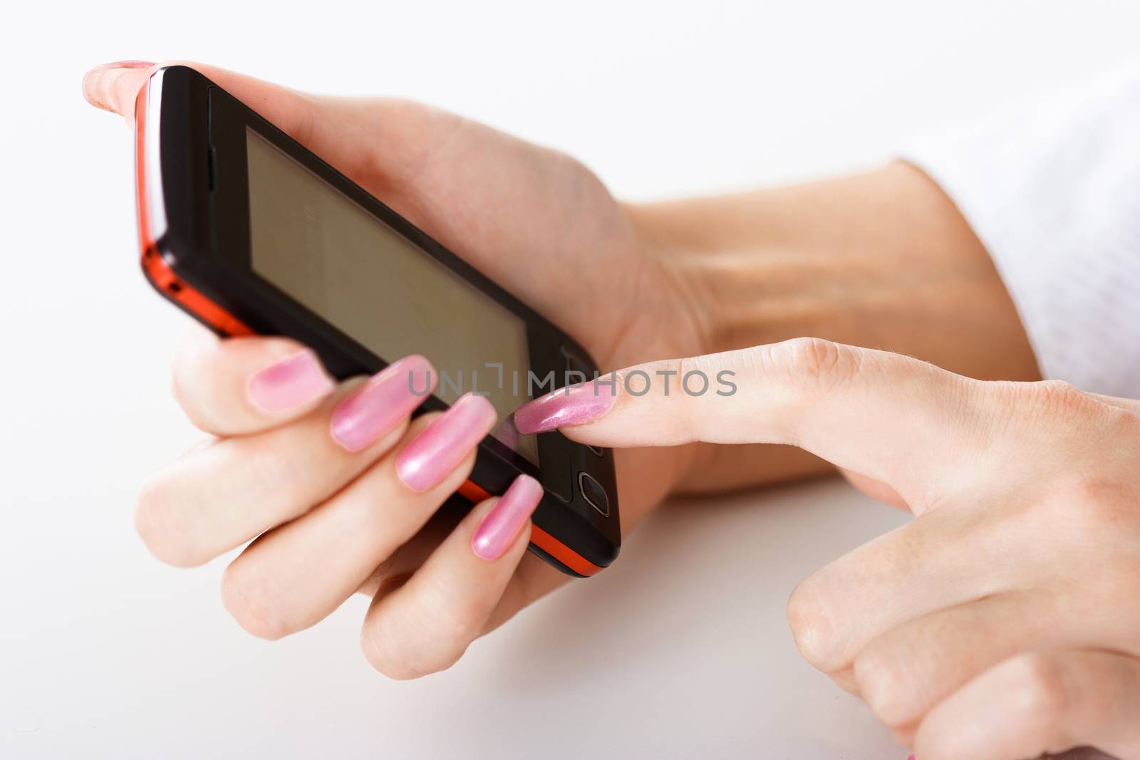 Mobile phone in a female hand. close-up