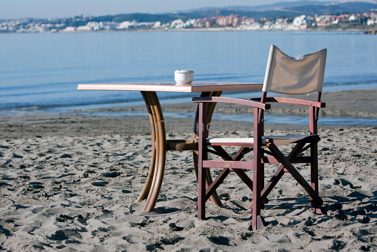 Empty Chair and Table on a  Beach, Spain