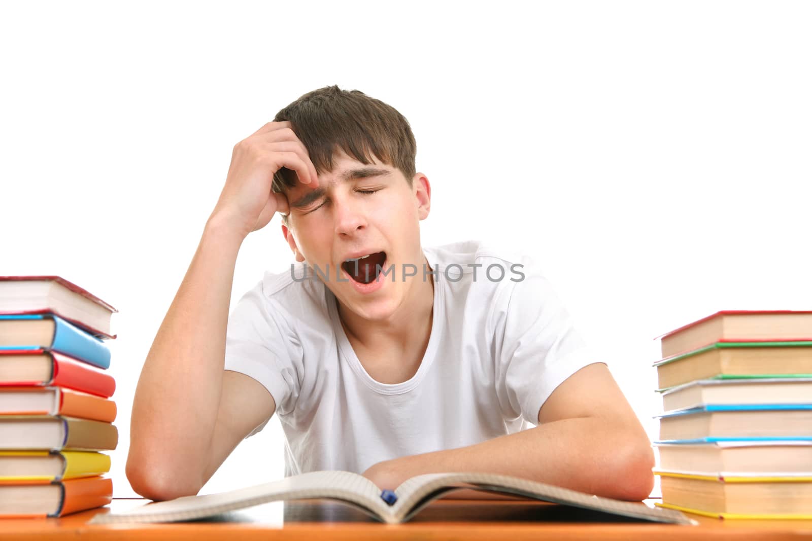 Tired Student Yawning on the School Desk Isolated on the White