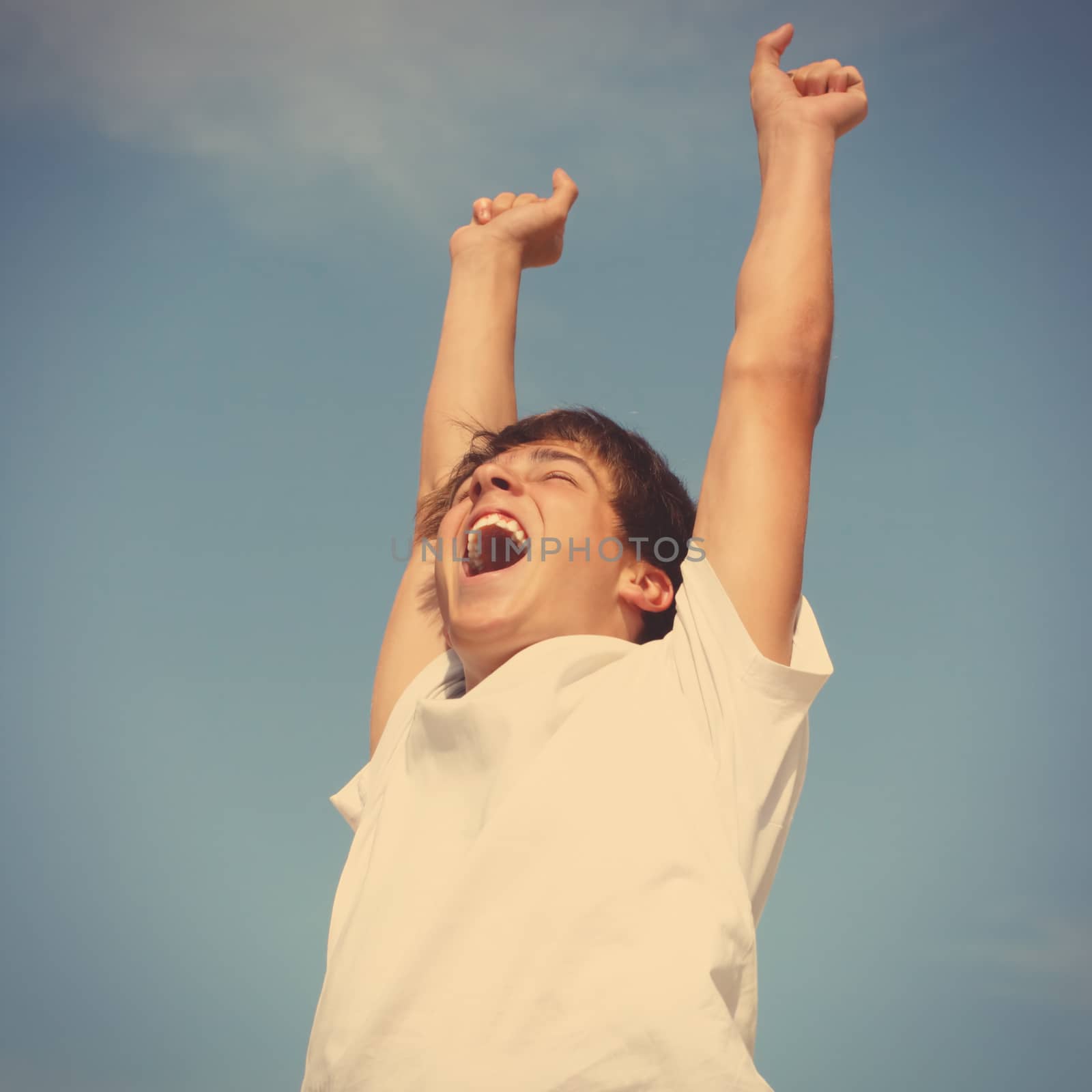 Toned photo of Happy Teenager jumping on sky background