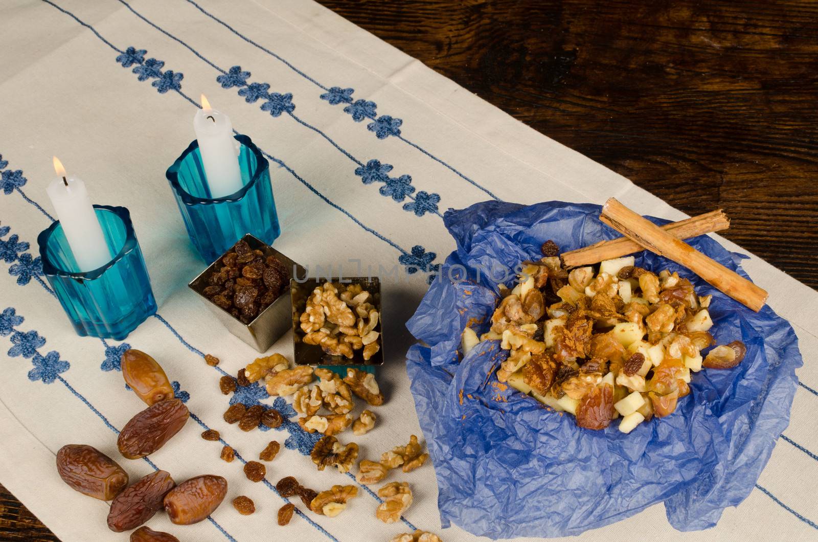 Haroset served on a festive table surrounded by its ingredients