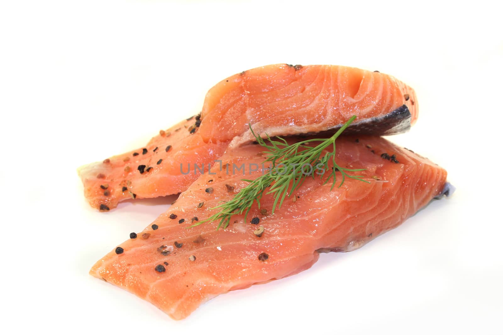 two raw pieces of salmon with dill