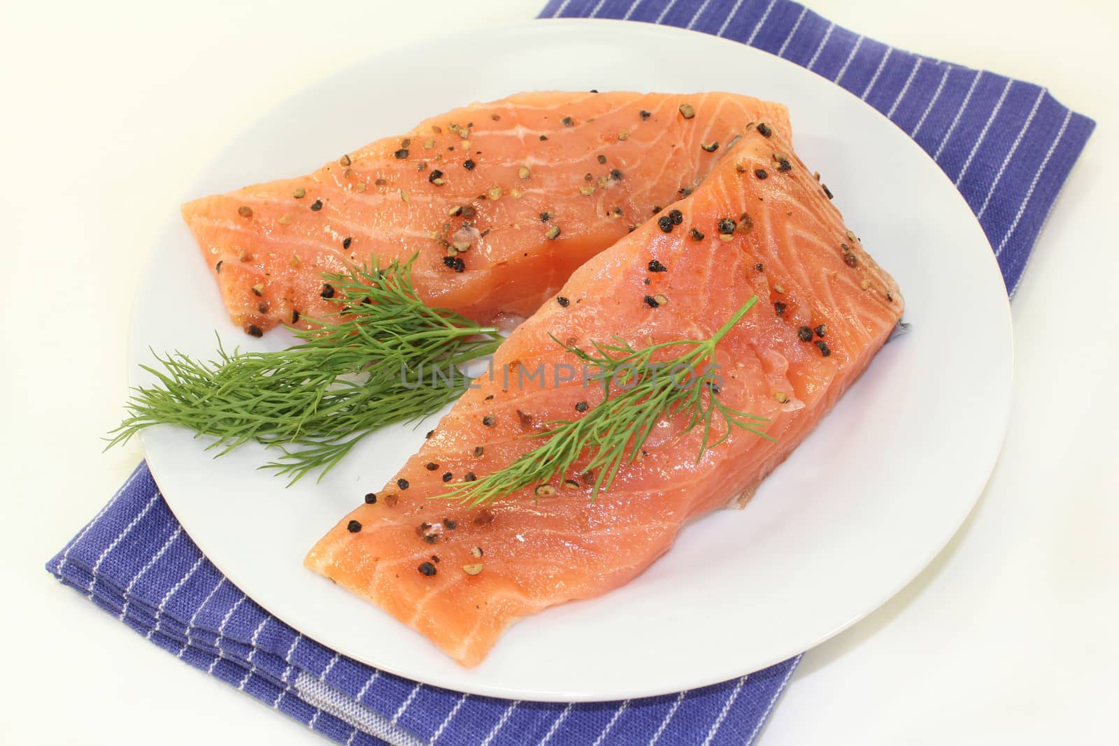 two raw pieces of salmon with dill