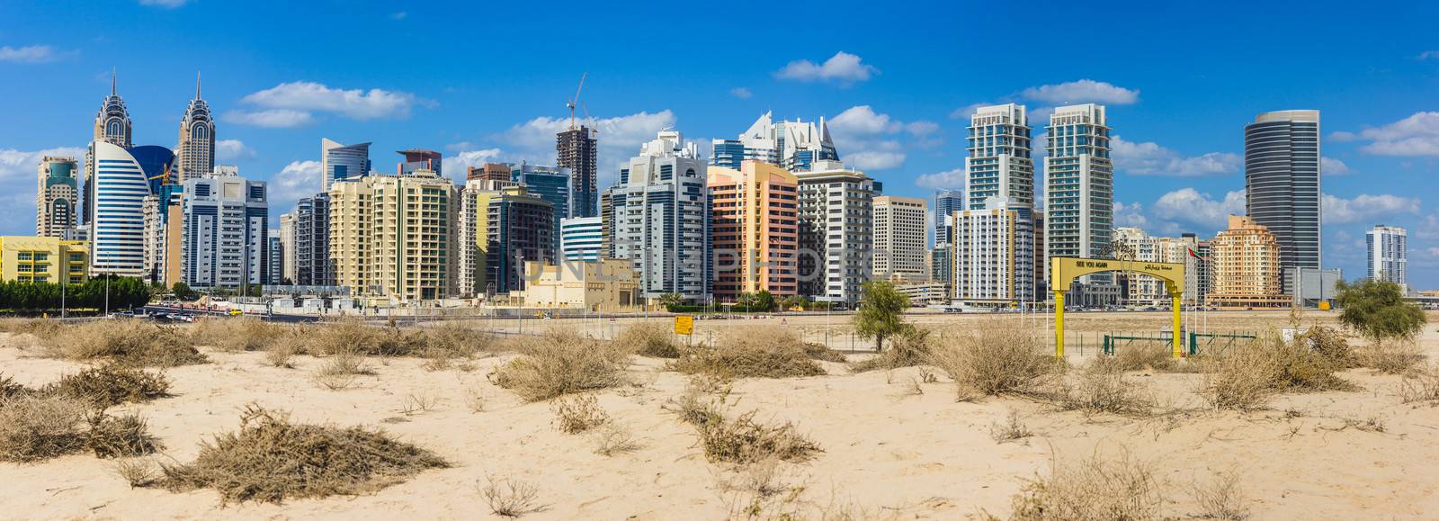 DUBAI, UAE - NOVEMBER 17: Midday heat in the desert in the background buildingsl on Nov 17, 2012 in Dubai UAE