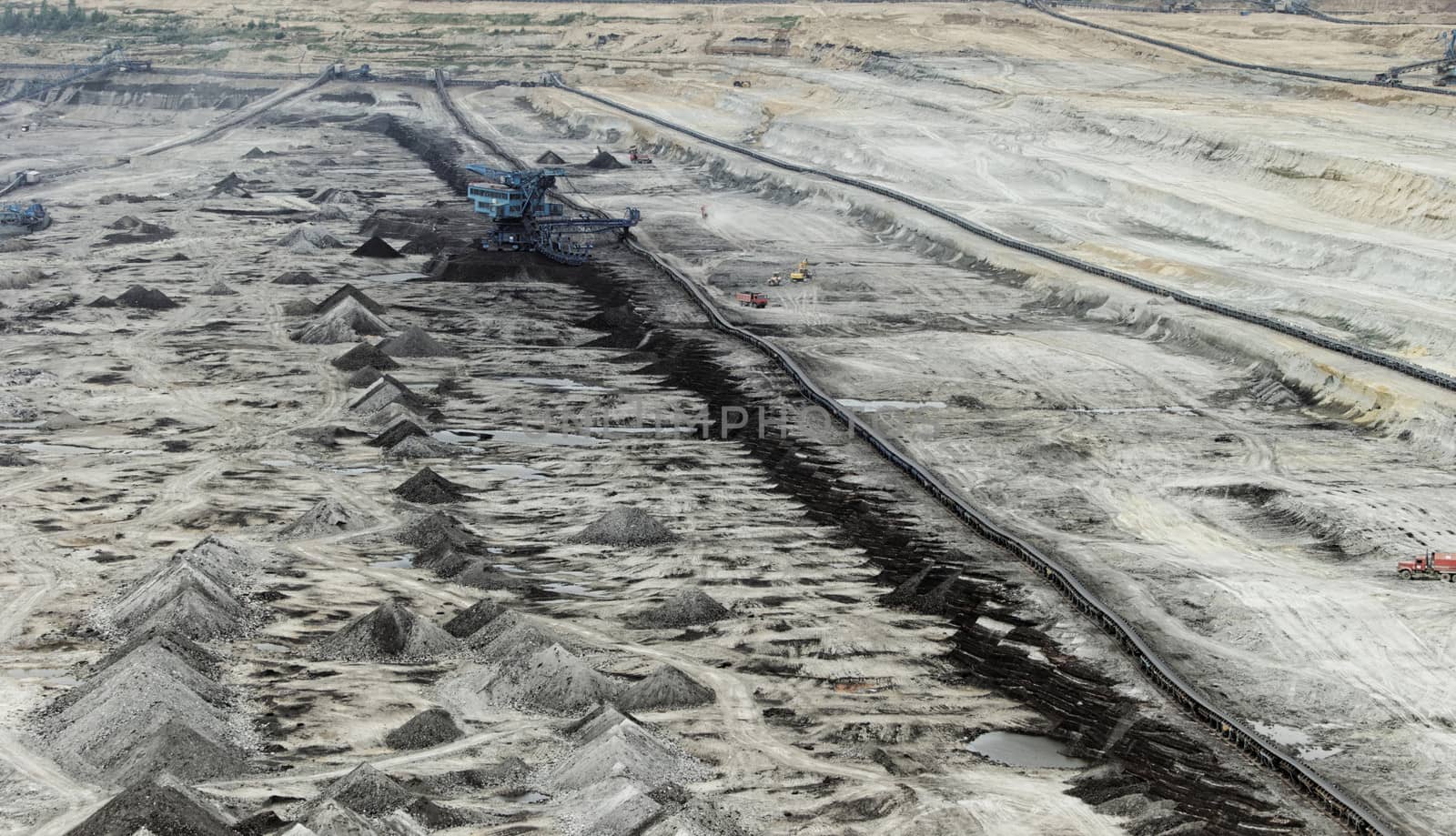 Coal mining in an open pit with huge industrial machine