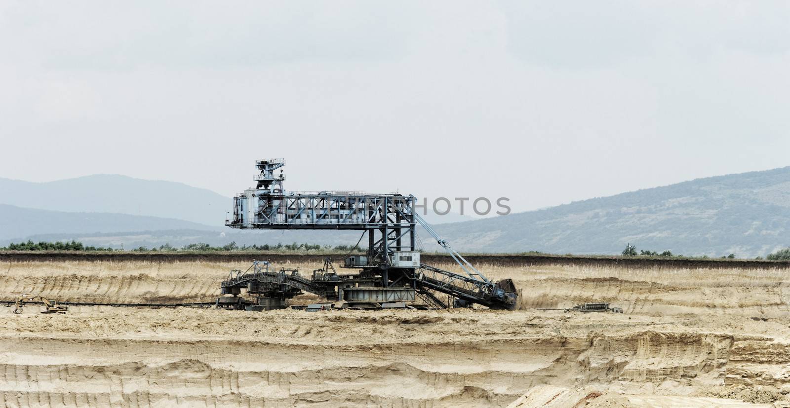 Coal mining in an open pit with huge industrial machine