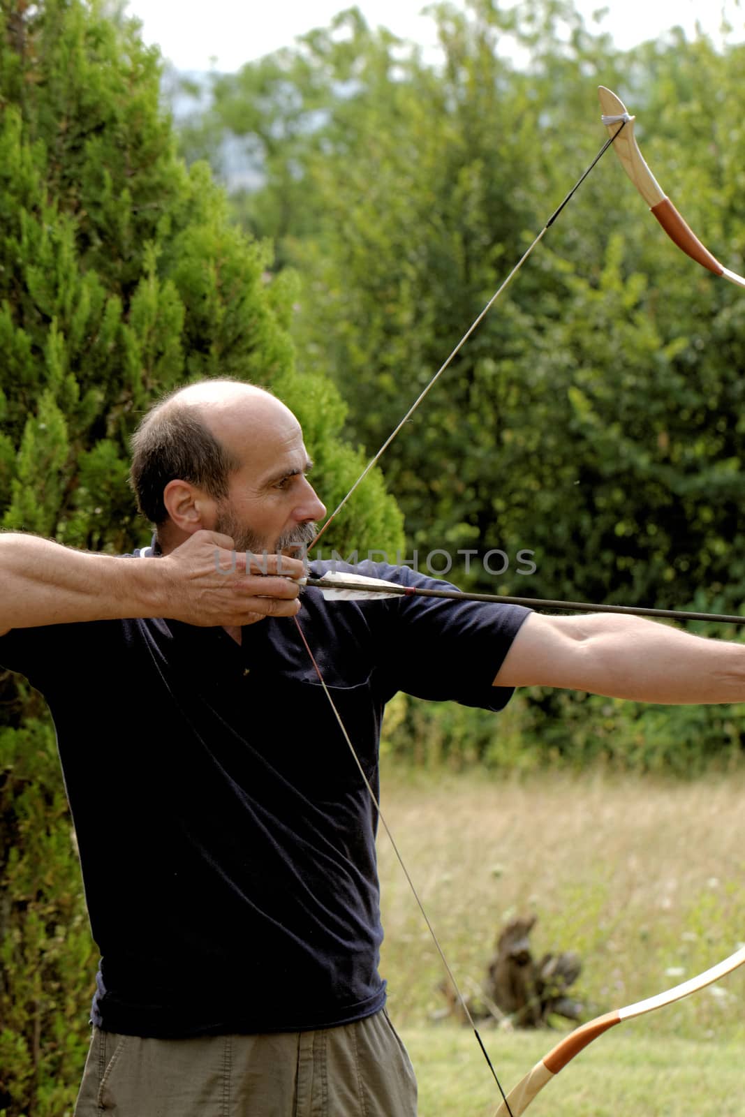 man shooting with bow by NagyDodo