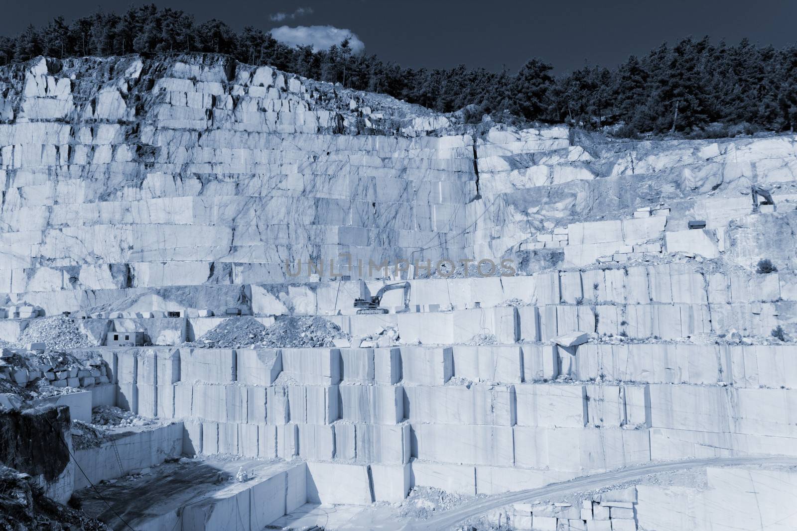 Detail of huge Thassos white marble quarry (mine) with grabber (color filtered photo) abstract