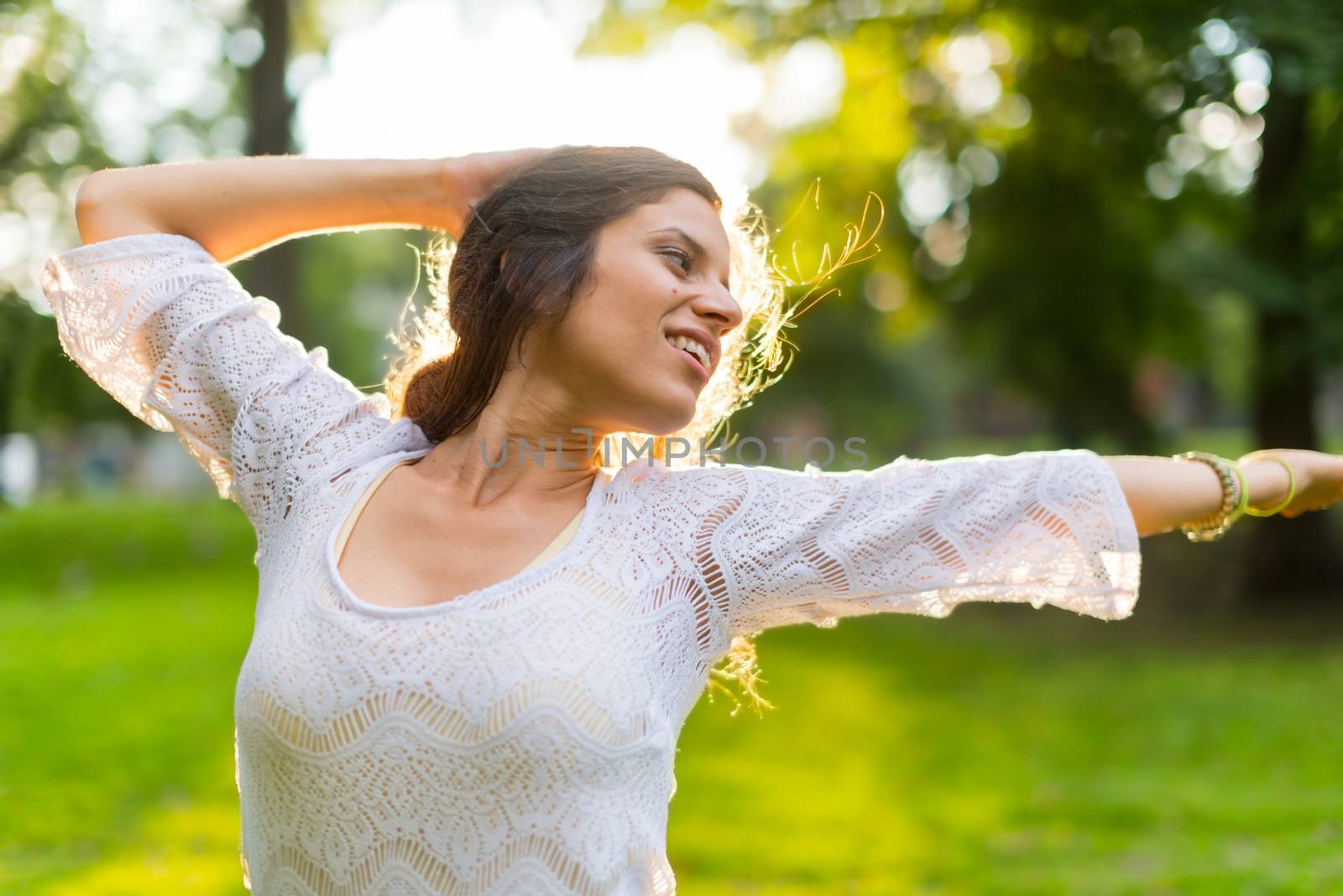 Beauty portrait of an attractive multi-ethnic girl enjoying warmth in a summer sunset. Sun Flare serie