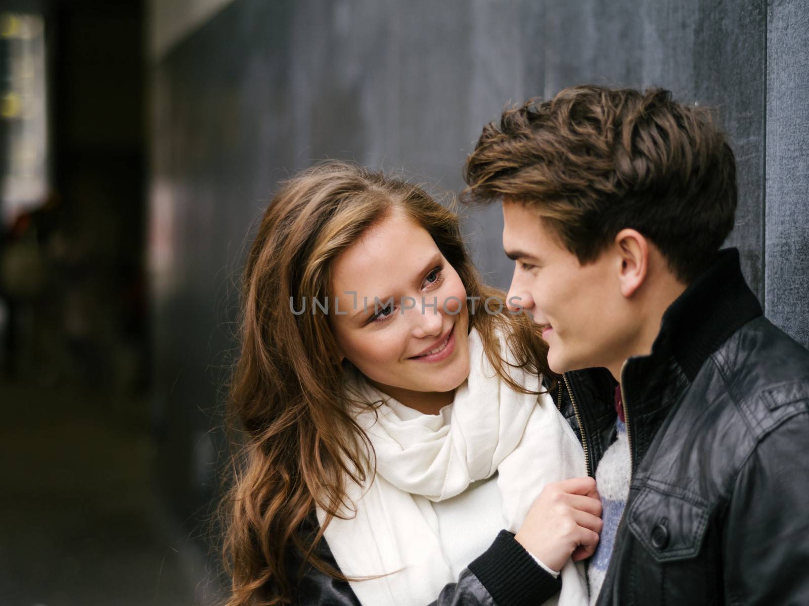 Photo of a happy couple in love outdoors during autumn.  Shallow depth of field with focus on the woman. Photo is from the PhotoWalk in Berlin during Microstock Expo.