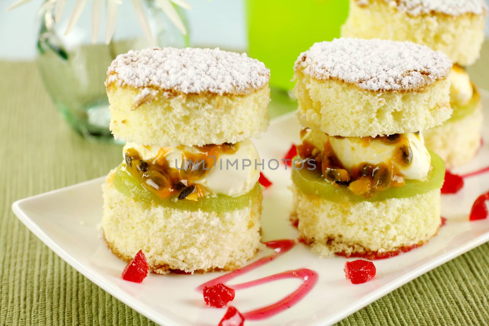 Delicious passionfruit sponge cake stacks served witha strawberry sauce.