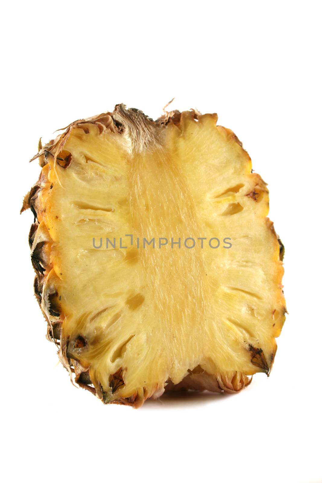 Fresh harvested pineapple cut in half.
