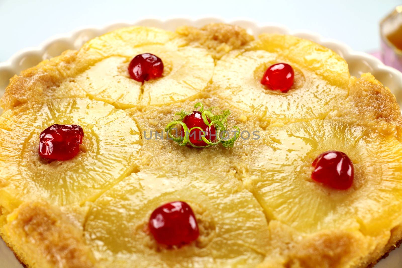Fresh baked pineapple upside down cake with glace cherries.