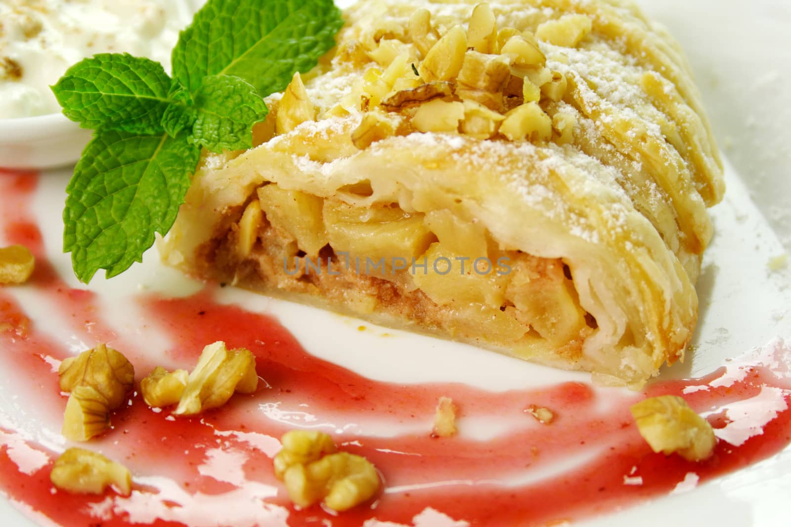 Delicious fresh baked plaited apple pie with walnuts ready to serve.