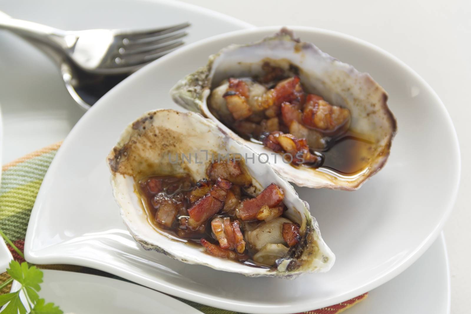 Delicious oysters kilpatrick with bacon and worcestershire sauce ready to serve.
