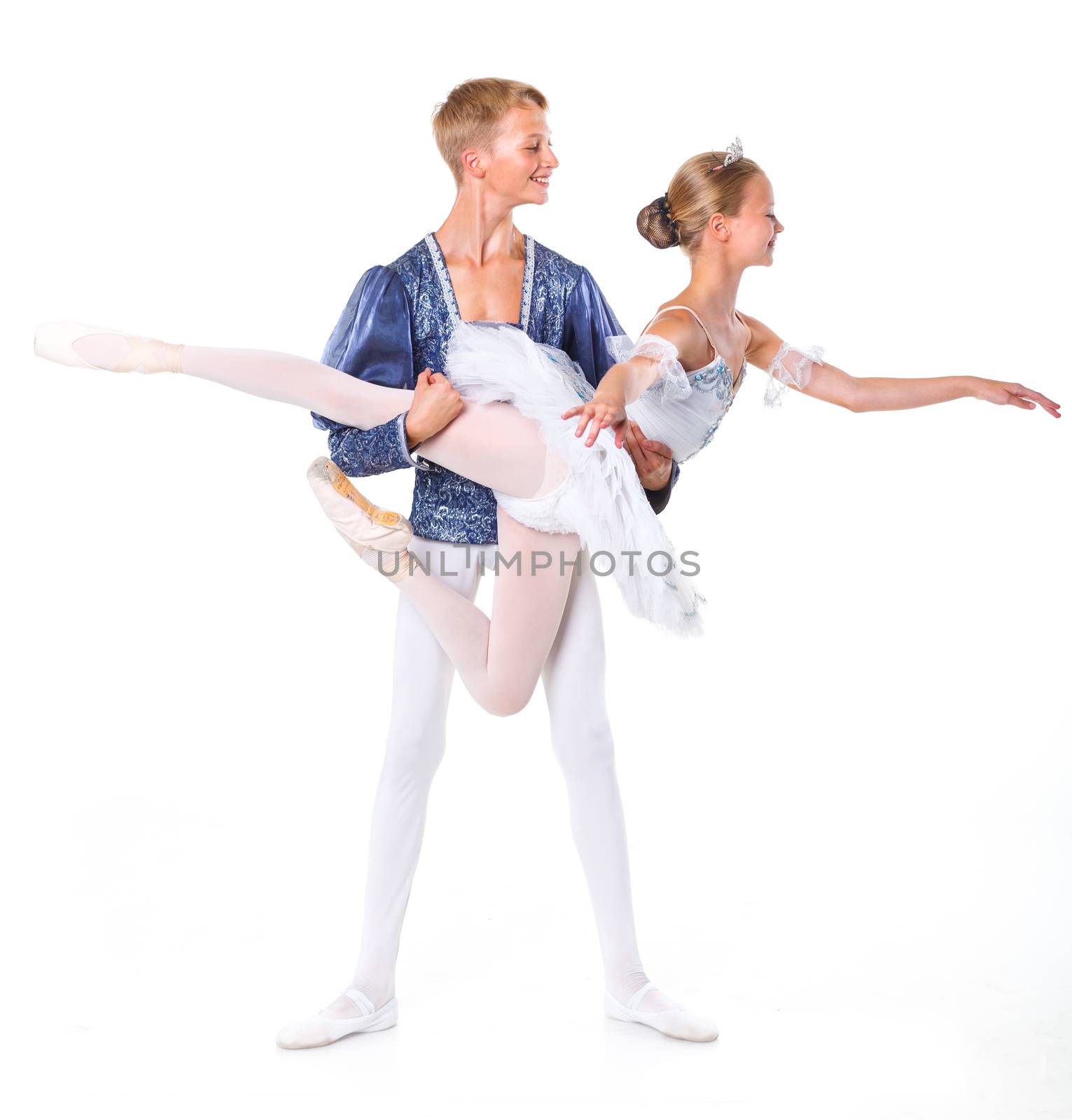 Couple of young ballet dancers posing over isolated white background