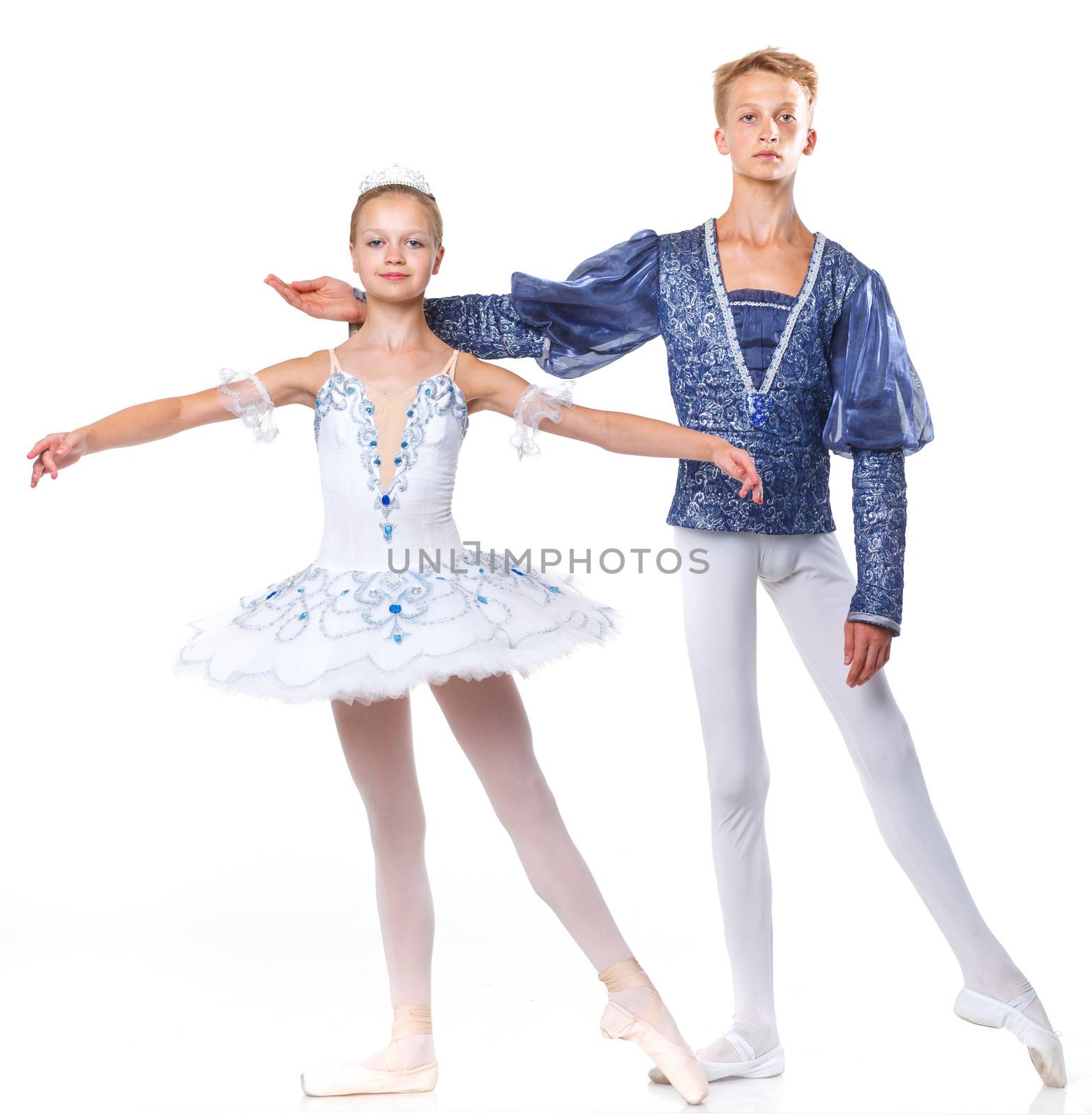 Couple of young ballet dancers posing over isolated white background