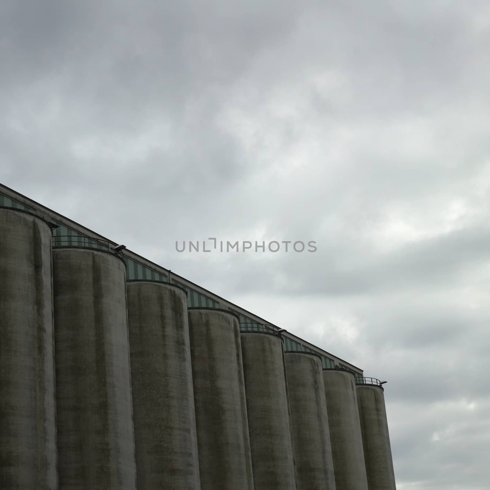 Large dark factory against grey sky