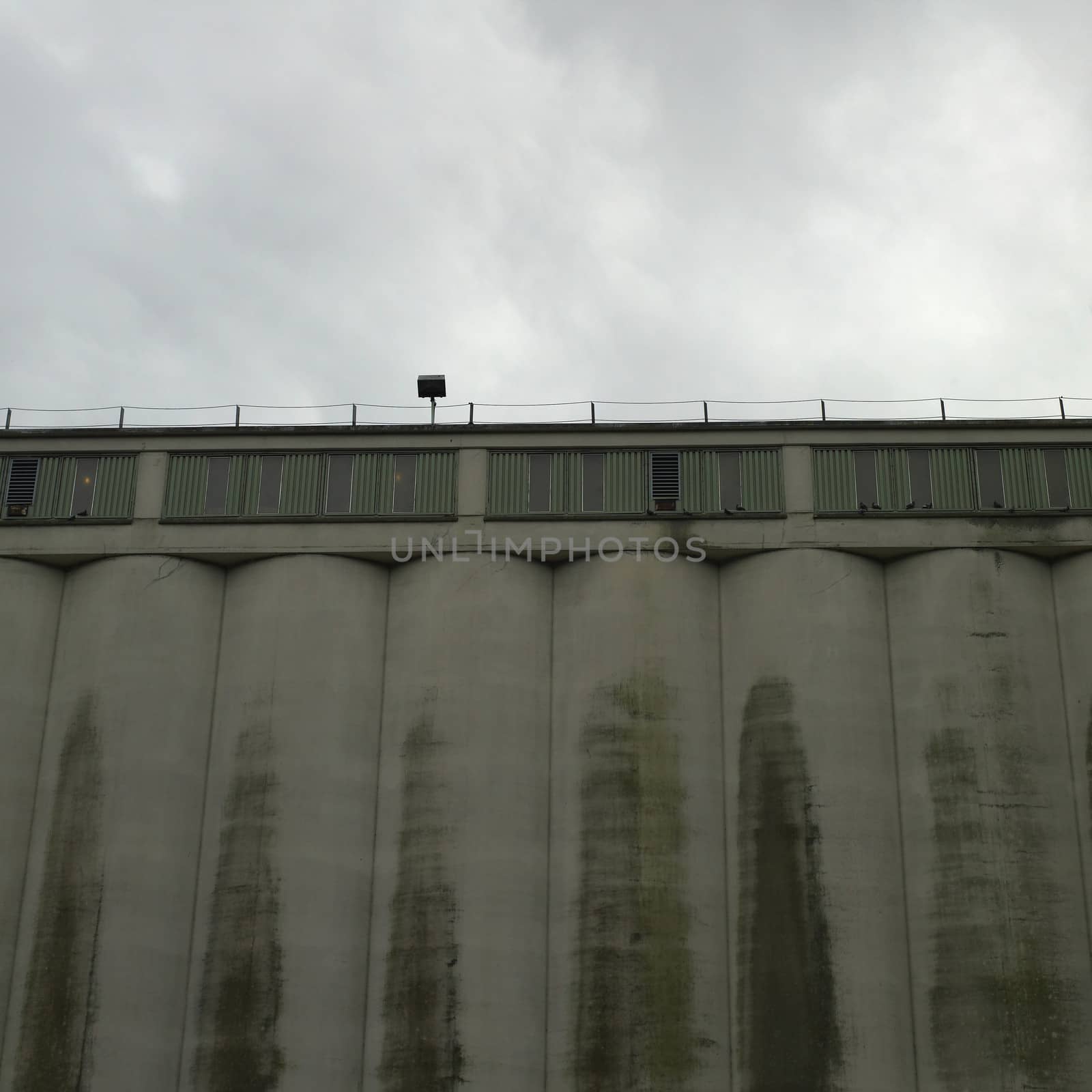 Large dark factory against grey sky