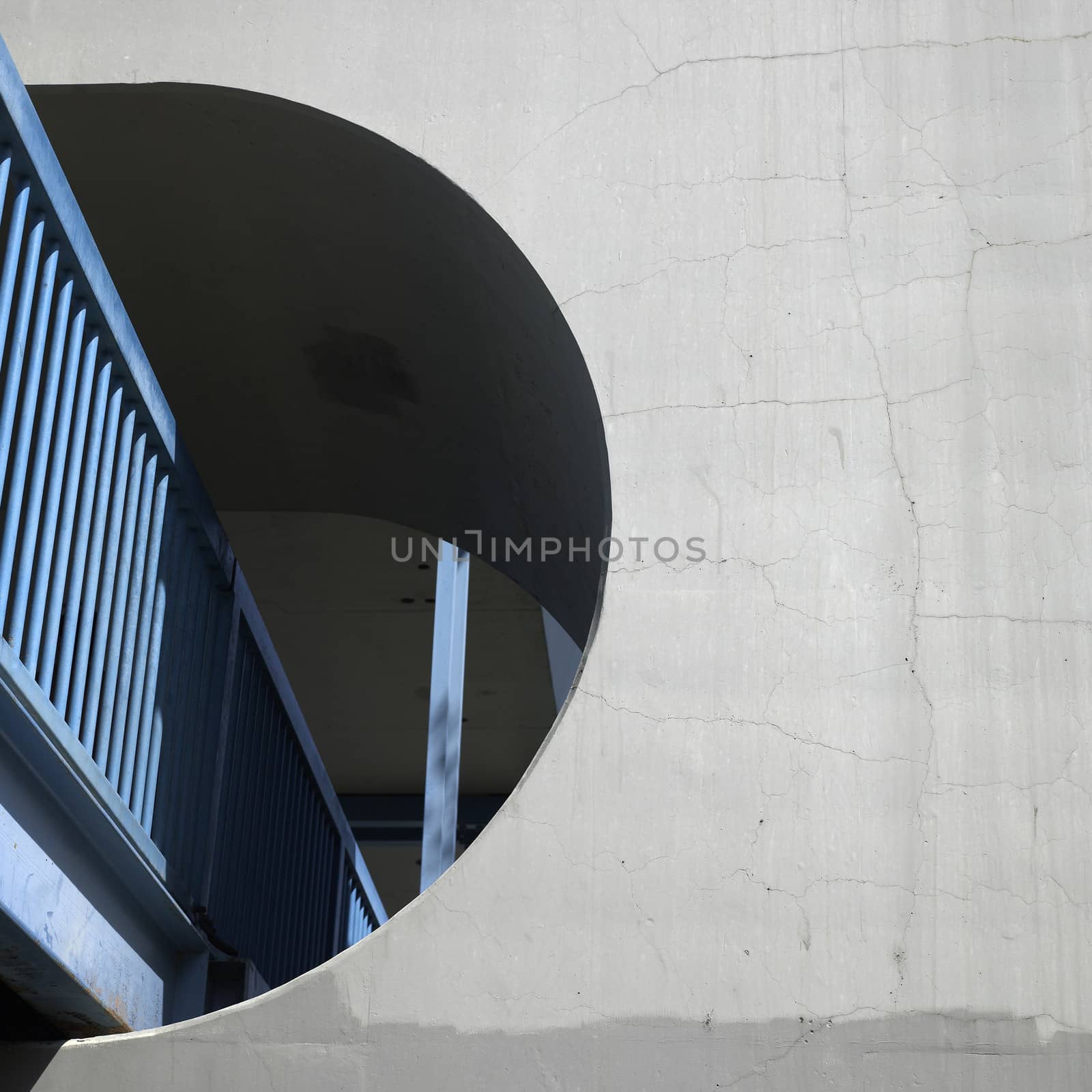 Blue aerial walkway with concrete wall