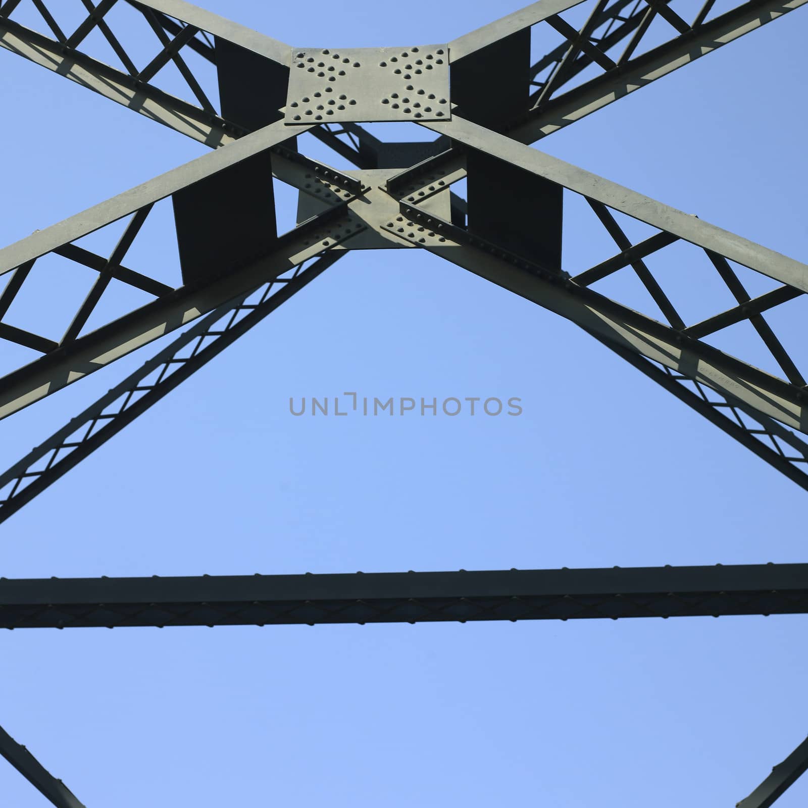 Heavy iron raillway bridge agains blue sky