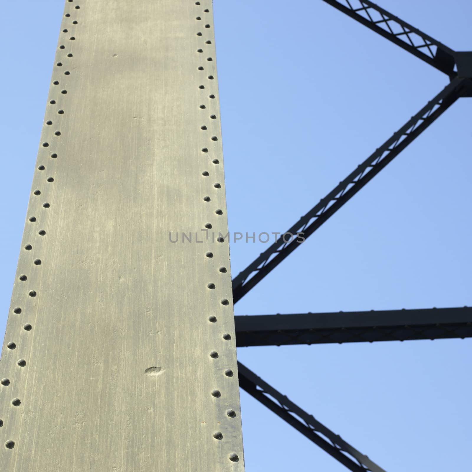 Heavy iron raillway bridge agains blue sky