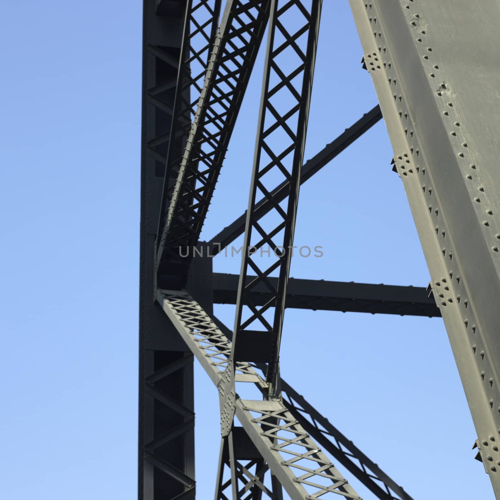 Heavy iron raillway bridge agains blue sky