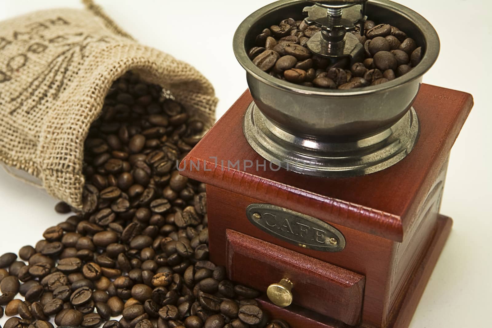 Roasted coffee beans are ground in a coffee grinder