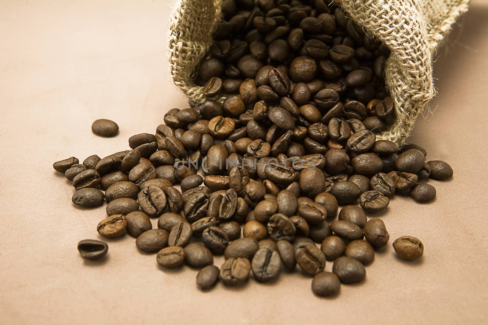Coffee beans in sack, burlap background