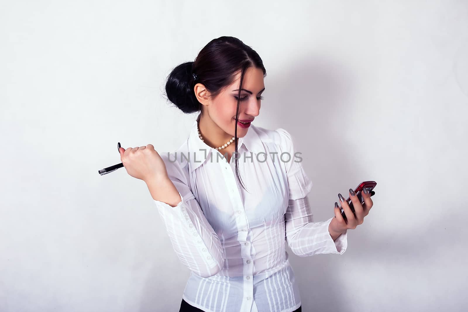 portrait of young business woman holding the cell phone