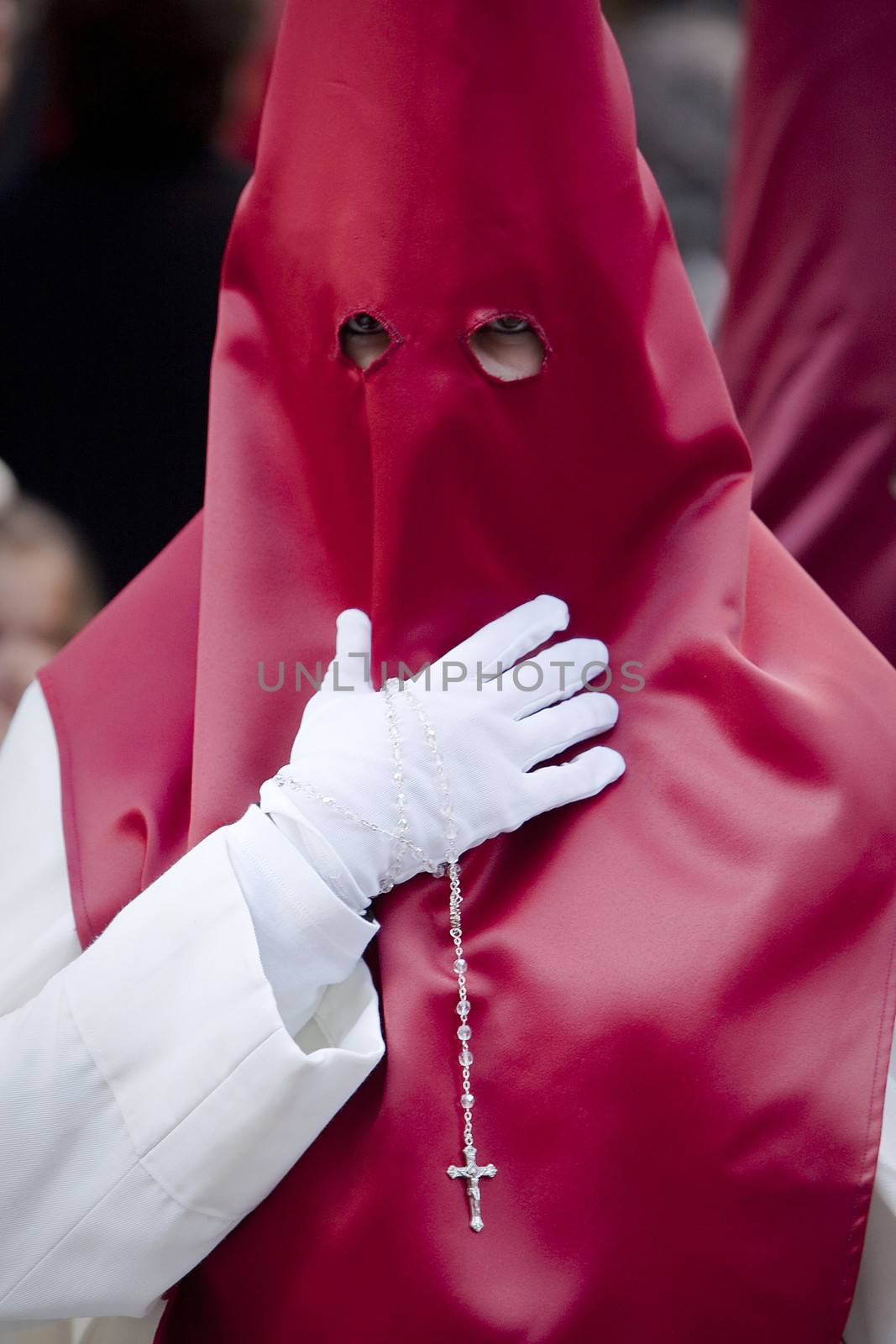 Penitent with a rosary in his hand in a procession, Spain